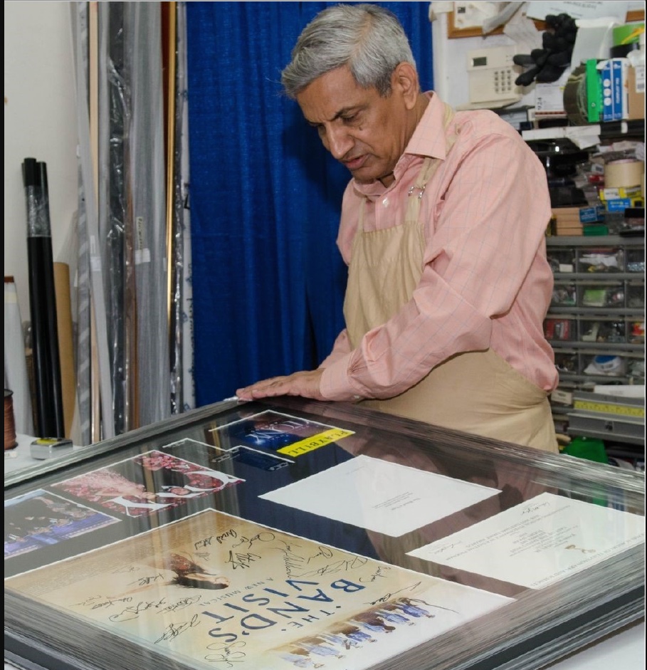A Perimeter Art framer assembling a shadowbox with signed memorabilia in the workshop